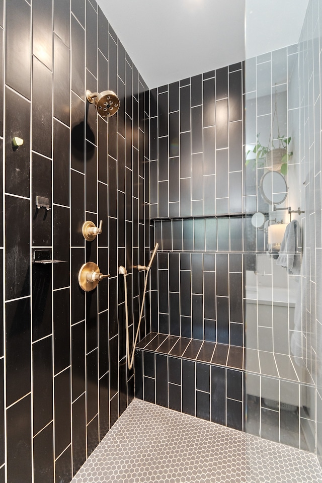 bathroom with a tile shower