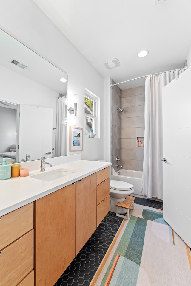 full bathroom with tile patterned flooring, vanity, toilet, and shower / bath combo with shower curtain