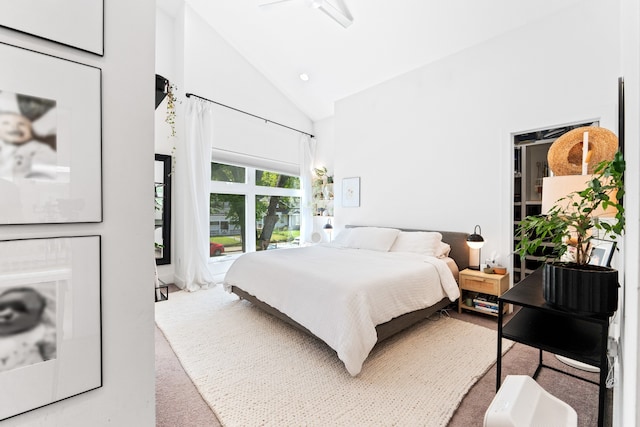 carpeted bedroom featuring ceiling fan and high vaulted ceiling