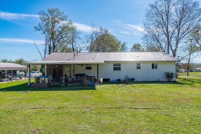 back of property featuring a yard and a carport