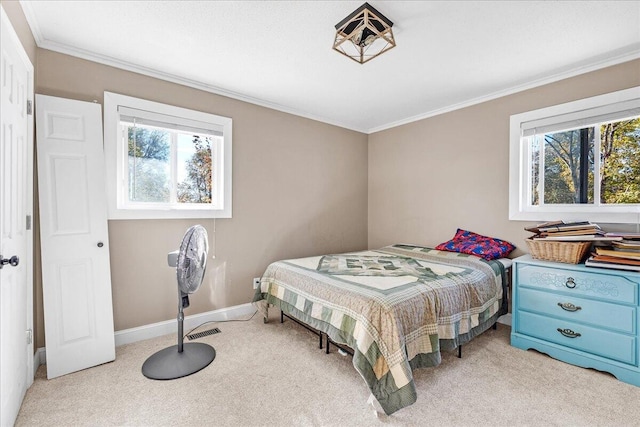 carpeted bedroom featuring multiple windows and crown molding