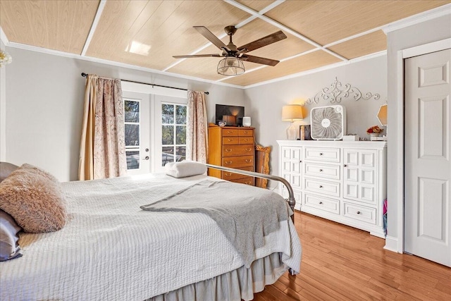 bedroom featuring access to exterior, french doors, ornamental molding, ceiling fan, and hardwood / wood-style flooring