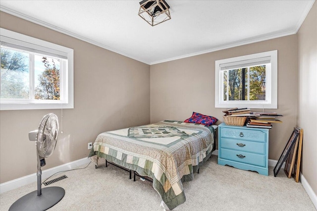 carpeted bedroom with multiple windows and ornamental molding