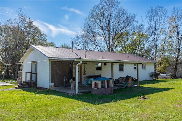 rear view of house with a yard and a patio area