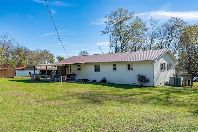 back of house with a lawn, cooling unit, and a patio area