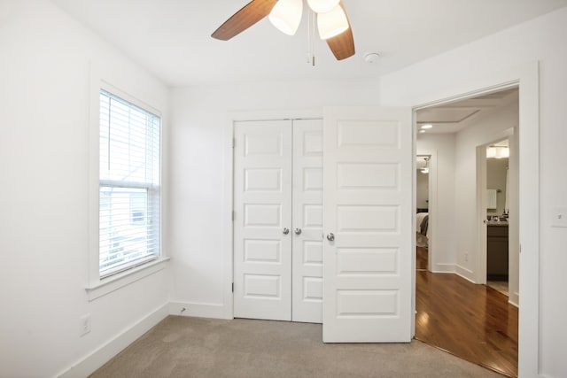 unfurnished bedroom featuring carpet flooring, a closet, and ceiling fan