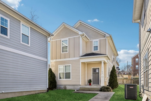 view of front of home featuring a front yard and cooling unit