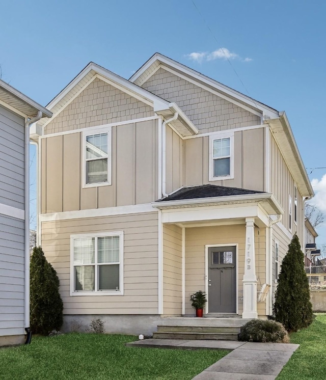 view of front of home featuring board and batten siding and a front yard