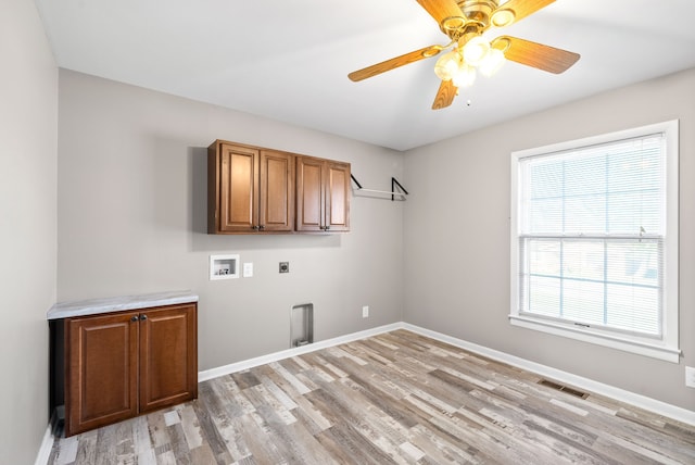 laundry room with ceiling fan, cabinets, washer hookup, hookup for an electric dryer, and light wood-type flooring