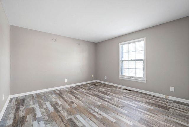 empty room with light hardwood / wood-style flooring