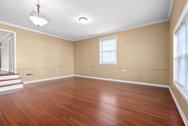 unfurnished room with dark wood-type flooring, crown molding, and a healthy amount of sunlight