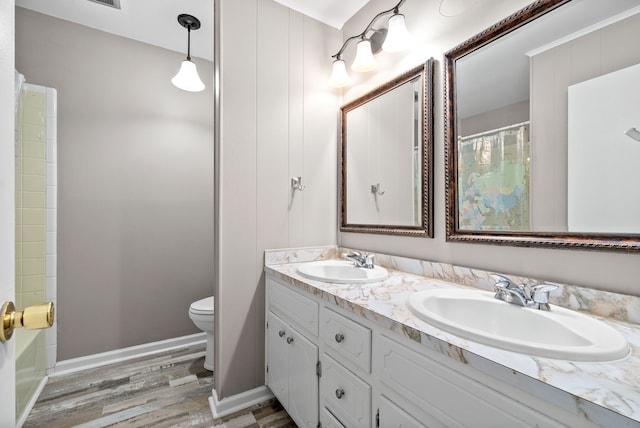 bathroom featuring wood-type flooring, vanity, and toilet