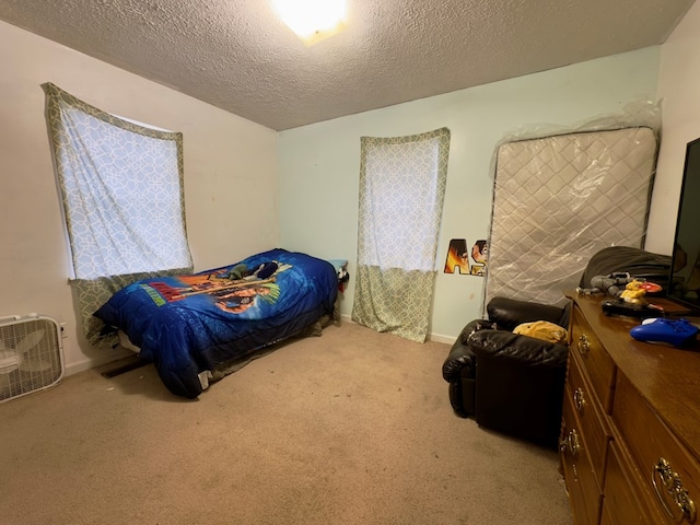 carpeted bedroom featuring a textured ceiling