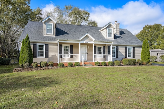 cape cod house featuring covered porch and a front yard