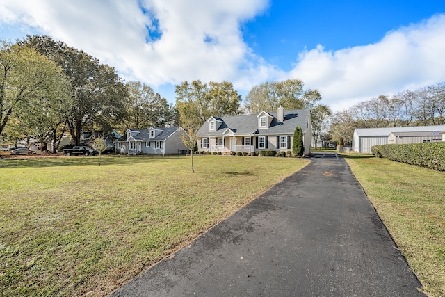 cape cod-style house featuring a front lawn