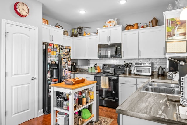 kitchen featuring black appliances, sink, white cabinetry, and dark wood-type flooring