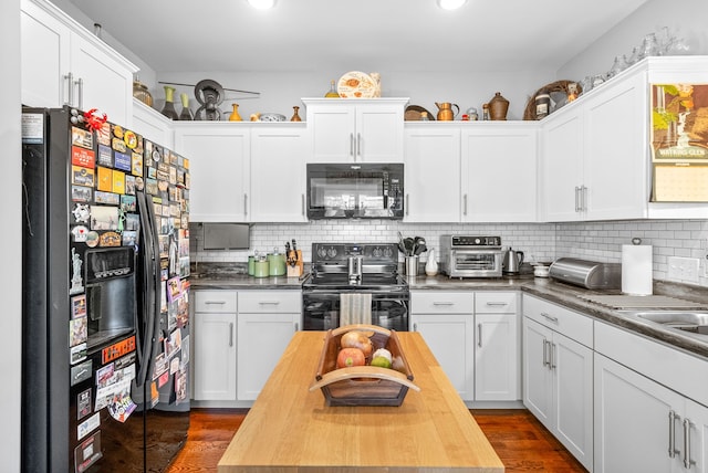 kitchen featuring tasteful backsplash, white cabinetry, black appliances, and dark hardwood / wood-style floors