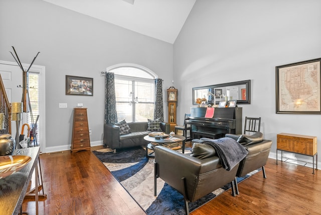 living room with hardwood / wood-style floors and high vaulted ceiling