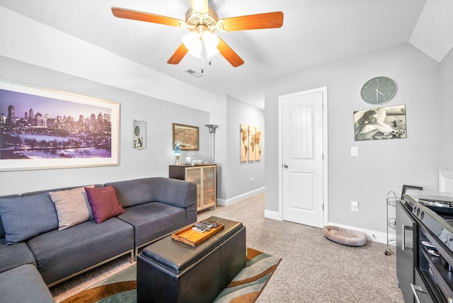 carpeted living room with ceiling fan and lofted ceiling