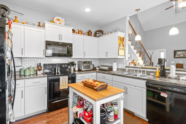 kitchen with sink, white cabinets, and black appliances