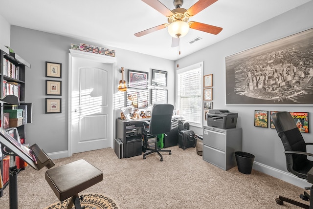 carpeted office space with ceiling fan