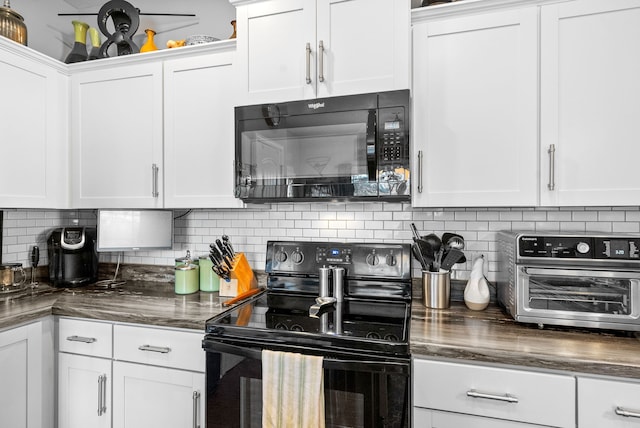 kitchen featuring black appliances, white cabinets, and backsplash