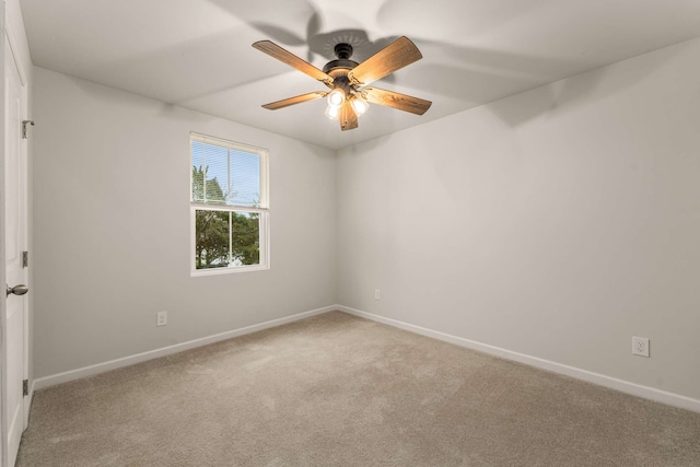 spare room with light colored carpet and ceiling fan