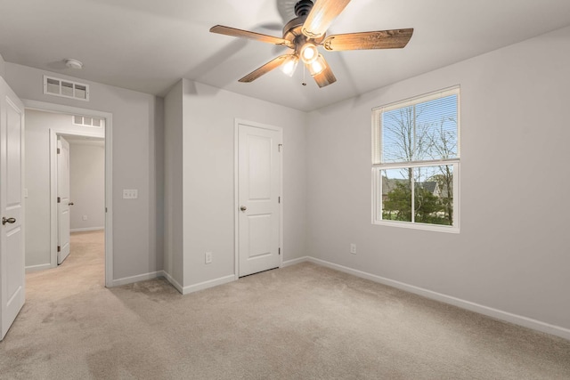 unfurnished bedroom with ceiling fan and light colored carpet