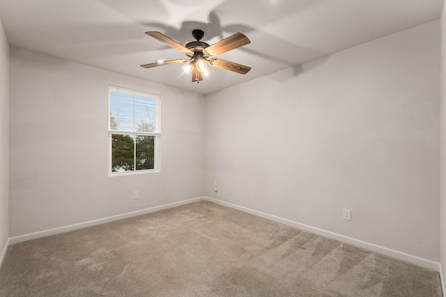 carpeted empty room featuring ceiling fan