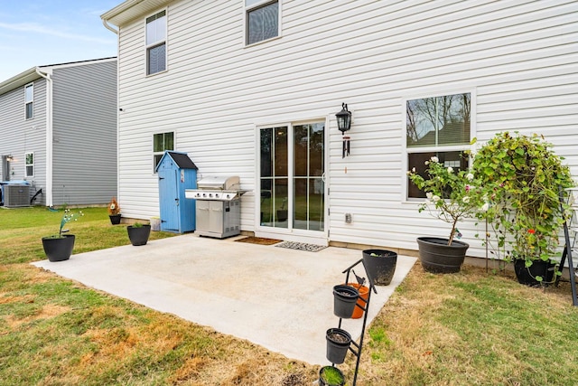 back of property with a yard, a patio, and central AC unit