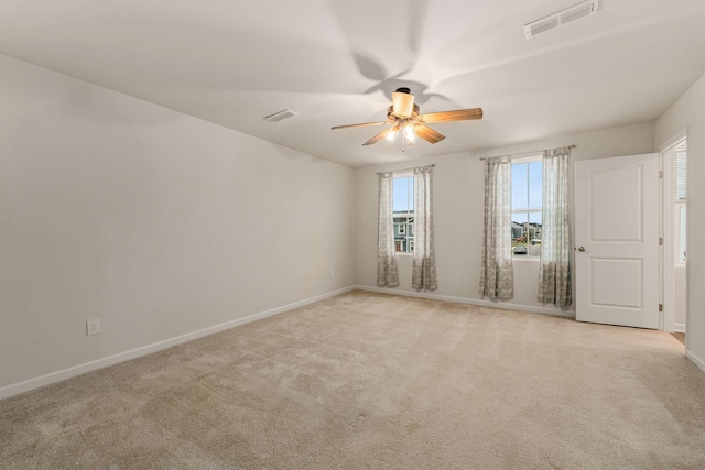 carpeted spare room with ceiling fan