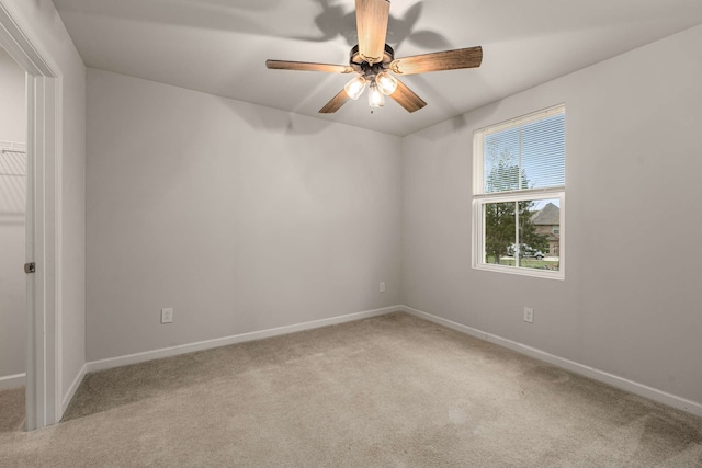 carpeted spare room with ceiling fan