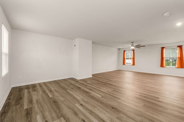 unfurnished room with ceiling fan and wood-type flooring