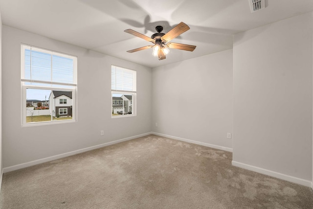 carpeted empty room featuring ceiling fan