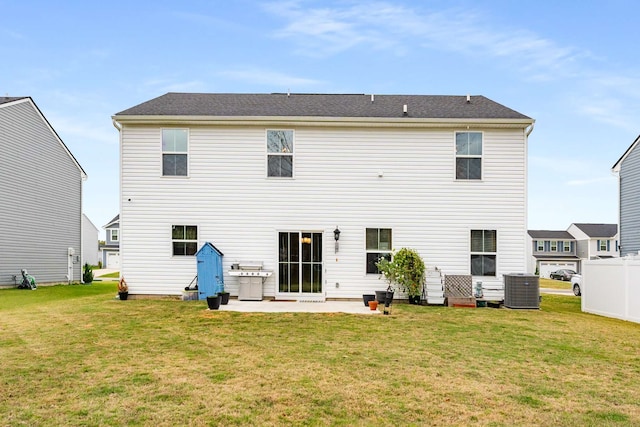 back of property featuring a yard, a patio, and central AC