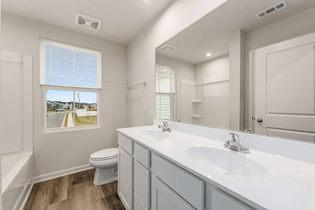 bathroom featuring toilet, vanity, and hardwood / wood-style flooring