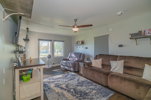 living room with dark hardwood / wood-style flooring and ceiling fan