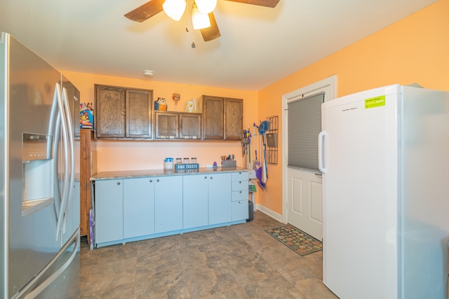 kitchen featuring ceiling fan, white refrigerator, and stainless steel fridge with ice dispenser