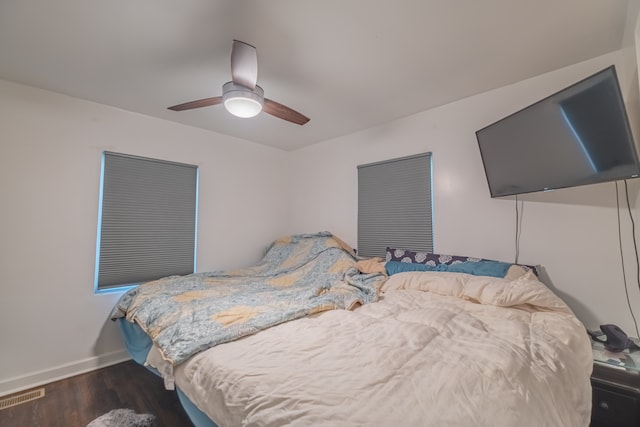 bedroom with ceiling fan and dark hardwood / wood-style floors