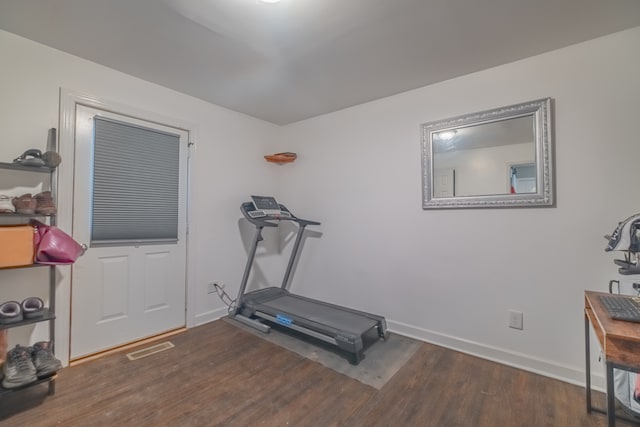 exercise area featuring dark wood-type flooring