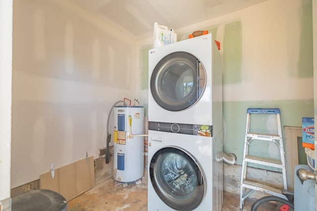 washroom featuring stacked washer / dryer and water heater