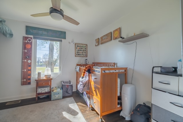 bedroom featuring ceiling fan and dark wood-type flooring