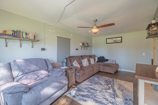 living room featuring ceiling fan and dark hardwood / wood-style floors