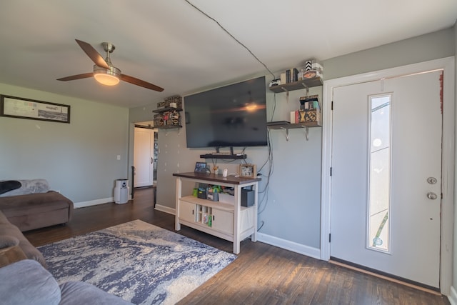 living room with ceiling fan and dark wood-type flooring