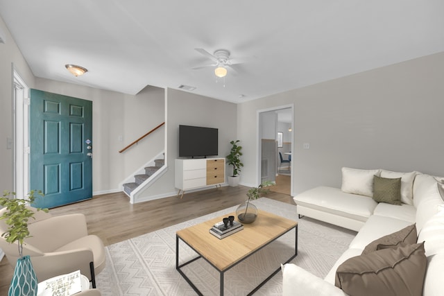 living room with light wood-type flooring and ceiling fan