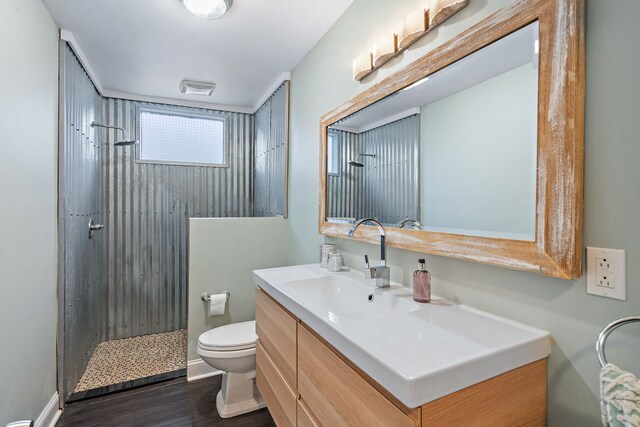 bathroom with a shower, vanity, wood-type flooring, and toilet