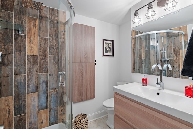 bathroom featuring vanity, toilet, and a shower with door