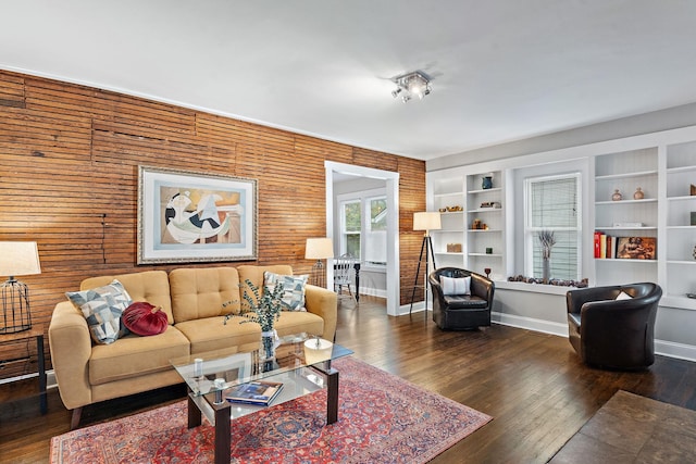 living room with dark hardwood / wood-style floors and built in features