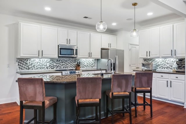 kitchen featuring dark hardwood / wood-style flooring, white cabinets, and appliances with stainless steel finishes