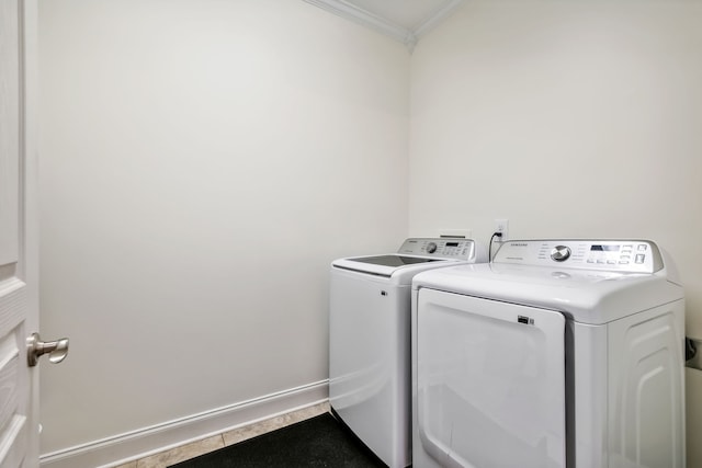 washroom featuring washer and dryer and ornamental molding